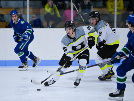 Ice hockey game in action with players skating and battling for the puck on a frozen rink, during a match.